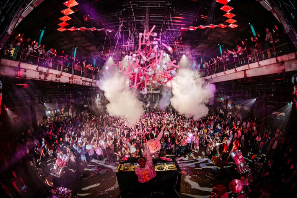 Een bovenaanzicht van de Middenfabriek waar mensen aan tafels zitten te eten.